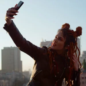 portrait-stylish-woman-making-selfie-photo-smartphone-city-view-stylish-hipster-girl-using-smartphon